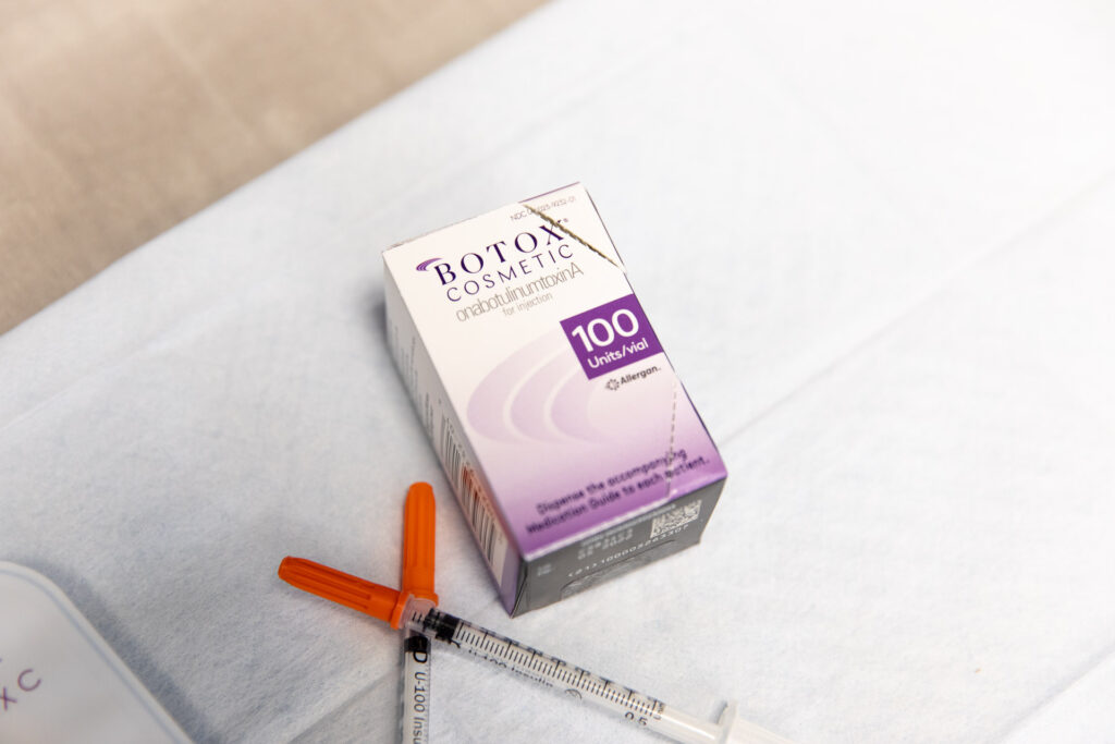 A box of Botox laying next to two syringes on a tray in preparation for treating a client for migraine relief in Nashville.