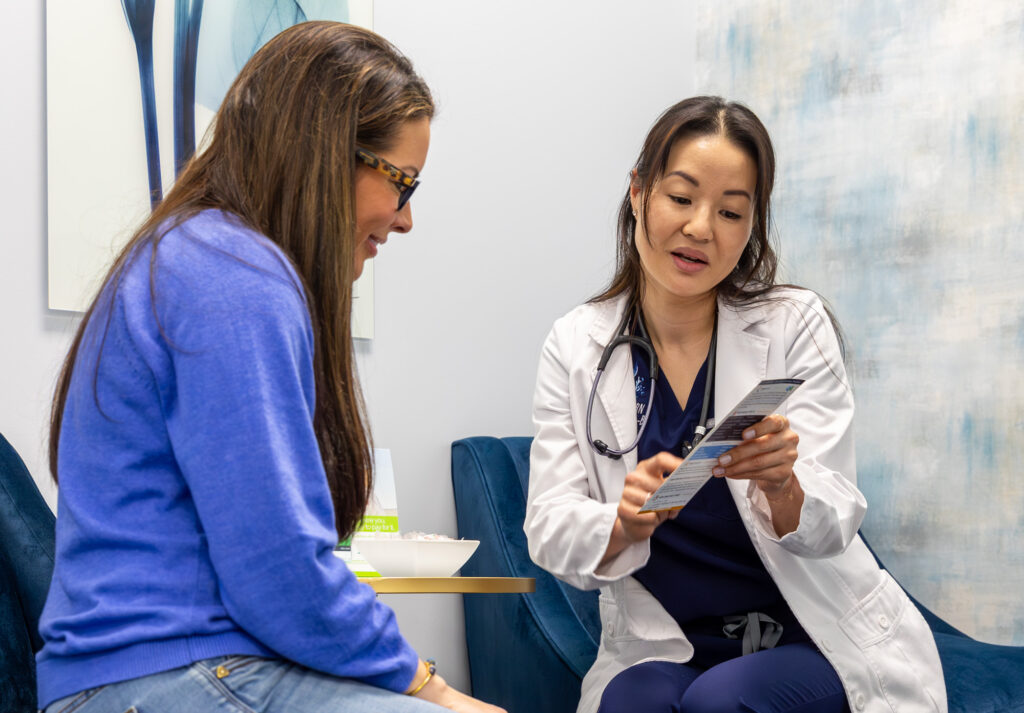 A doctor discusses a female patient's options for intravenous therapy near Brentwood, TN