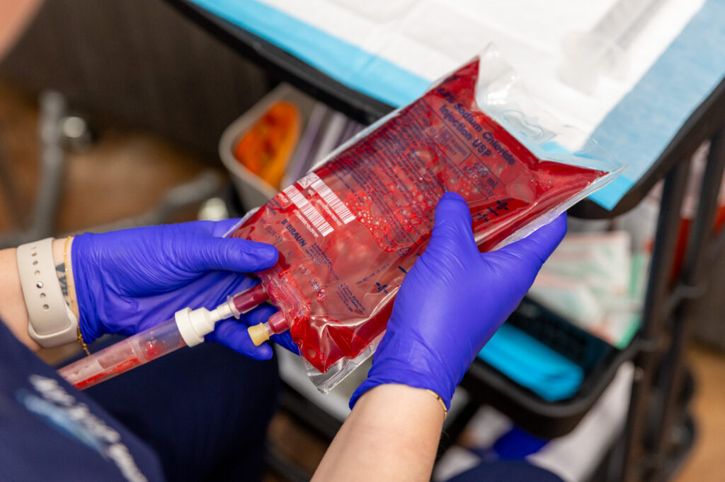 An alternative medicine Dr. in Nashville holds an IV bag that will be used for ozone therapy.