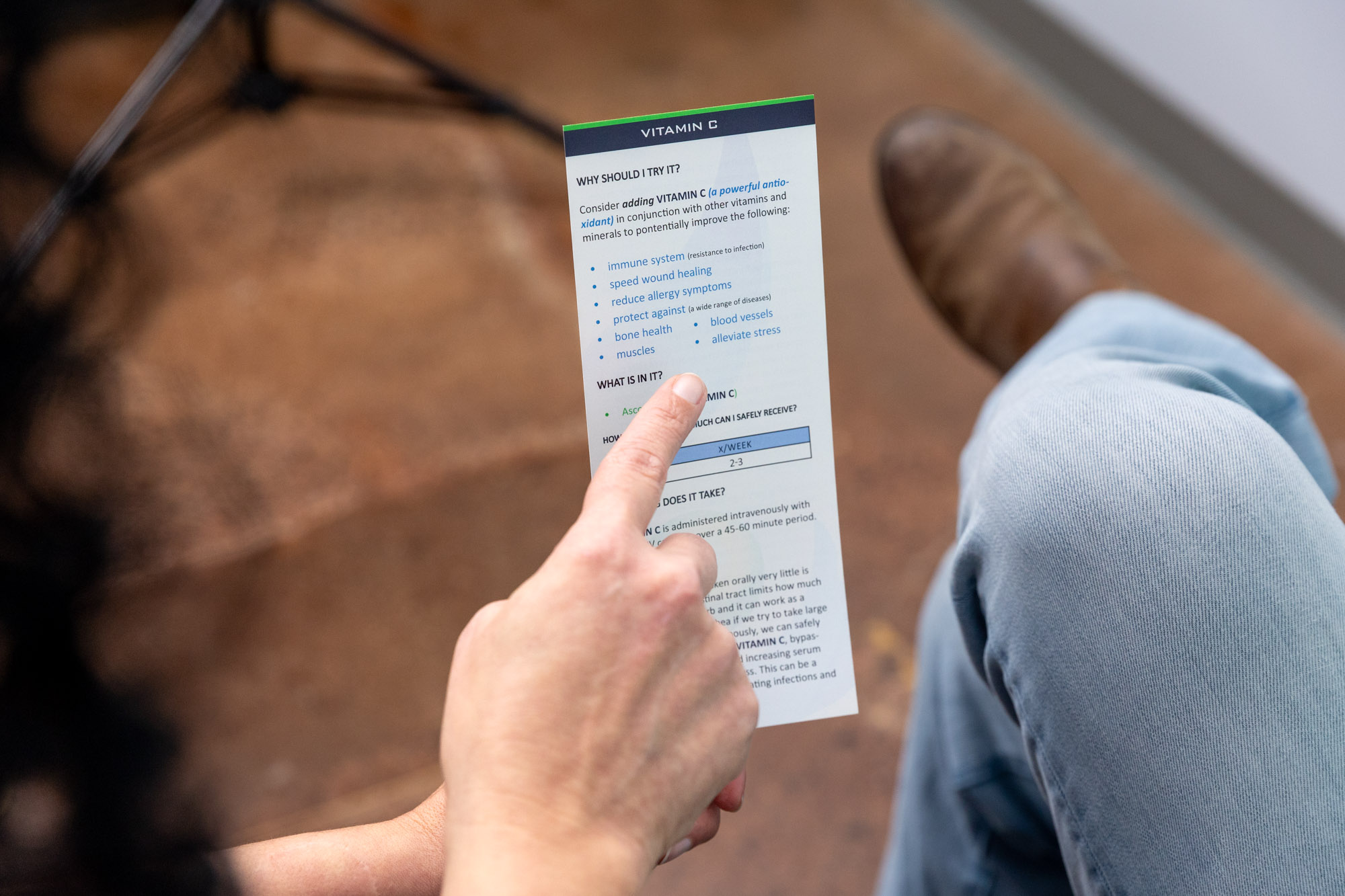 A patient browses a catalog of IV add-ons to customize their immune system booster in Franklin, TN
