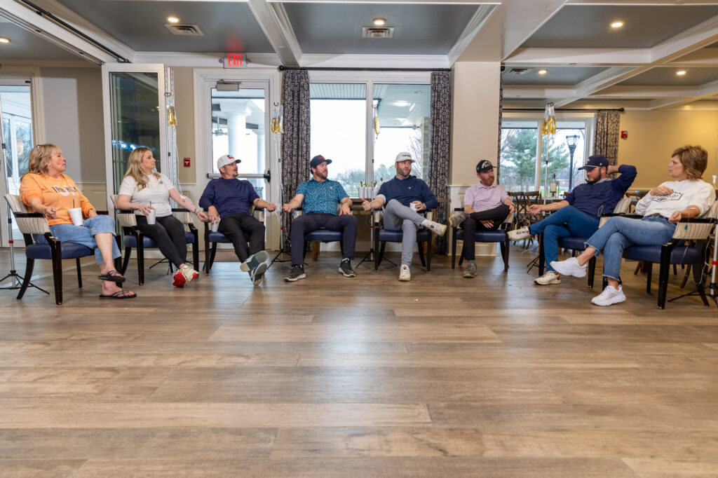 A group of men and women sit in a clubhouse receiving IVs that act as a hangover headache cure in Hendersonville.